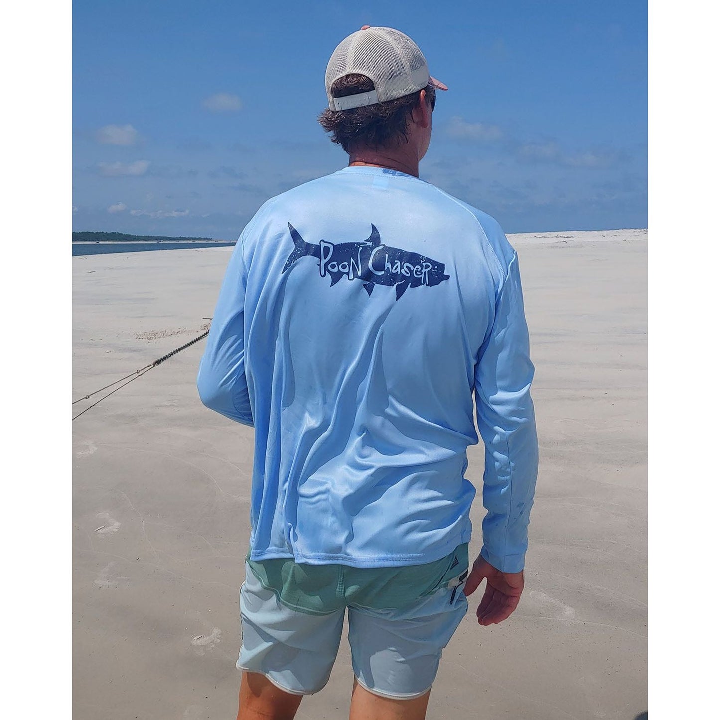 Model wearing light blue long sleeve Tarpon "Poon Chaser" performance fishing shirt with 50+ UPF sun protection