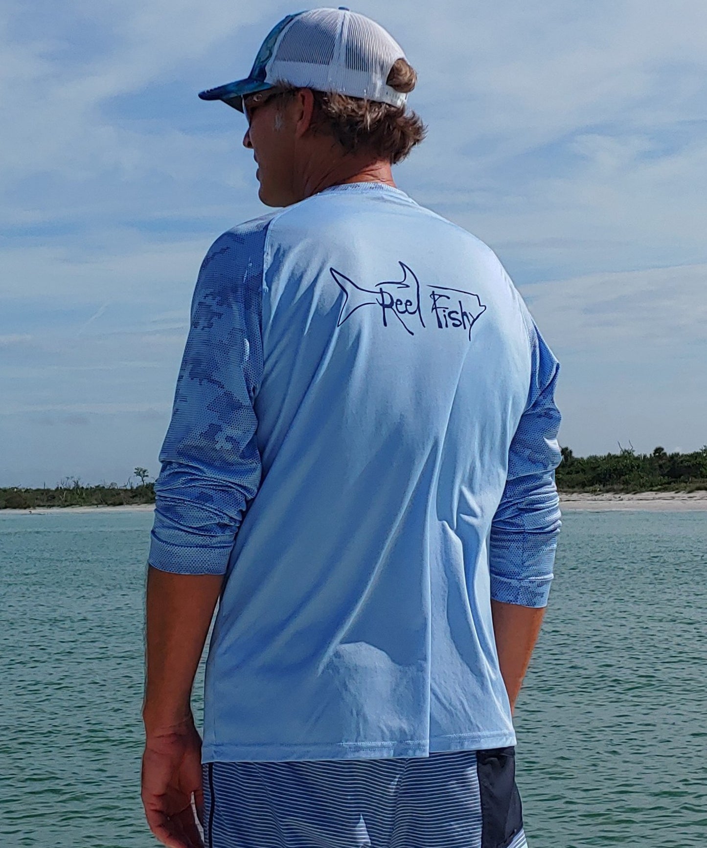 Model wearing Reel Fishy Tarpon Digital Camo Dry-Fit Long Sleeve Shirt in Blue Mist with 50+ UPF Sun Protection