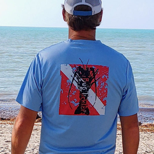 Model wearing Lobster Performance light blue short sleeve fishing shirt with 50+ UPF sun protection and "Bug Tickler" dive logo