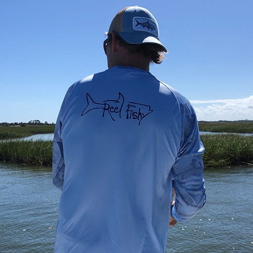 Fisherman wearing Reel Fishy Mens Performance Camo Dry-Fit 50+ UV Sun Protection Shirt