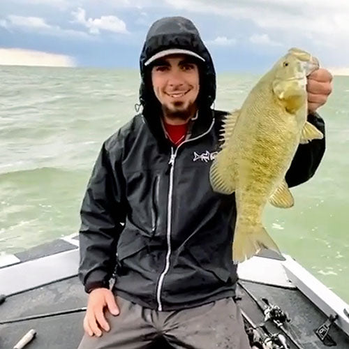 Bass Fisherman wearing Reel Fishy Apparel Rain Jacket with Hood