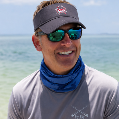 Model wearing a blue crab cotton visor in navy on the water in Key West, FL