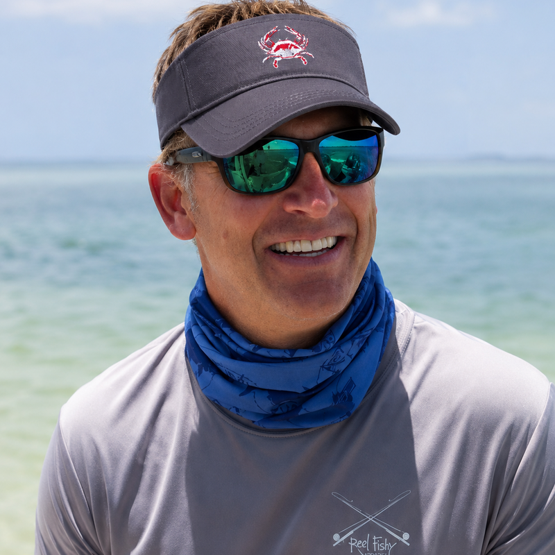 Model wearing a blue crab cotton visor in navy on the water in Key West, FL