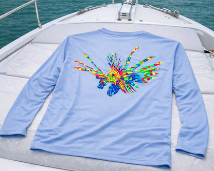 Light blue long-sleeve shirt with colorful lion fish design on a boat deck.