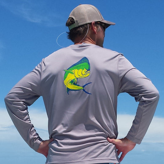 Model wearing a gray performance UPF 50 shirt with a Mahi graphic on the back