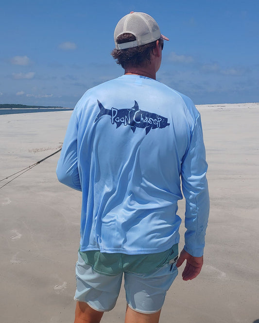 Model wearing light blue long sleeve Tarpon "Poon Chaser" performance fishing shirt with 50+ UPF sun protection