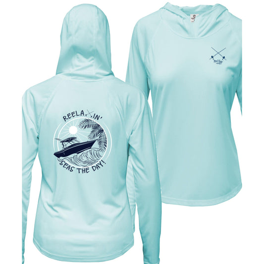 Ladies light blue long sleeve performance hoodie, thumb holes, fishing boat and Seas the Day graphic, Reel Fishy salt fishing rods logo on front.