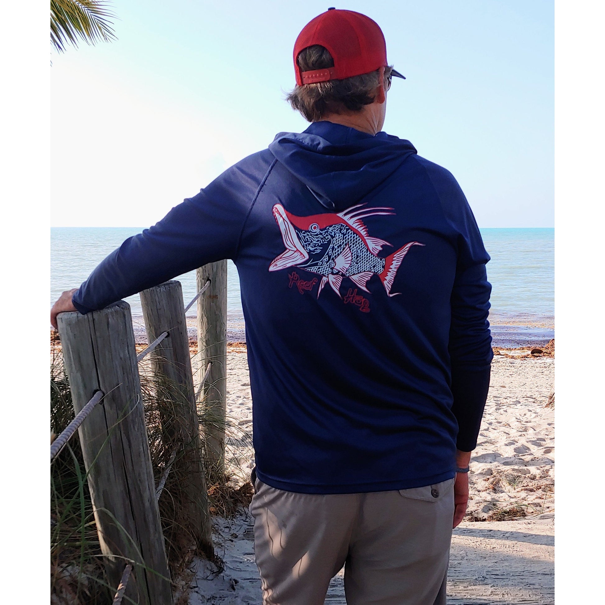 Model wearing navy Hogfish Reef Hog dri-fit 50+ sun protection long sleeve hoodie