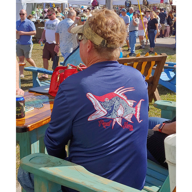 Model wearing navy long sleeve Hogfish Performance 50+ UPF shirt by Reel Fishy Apparel