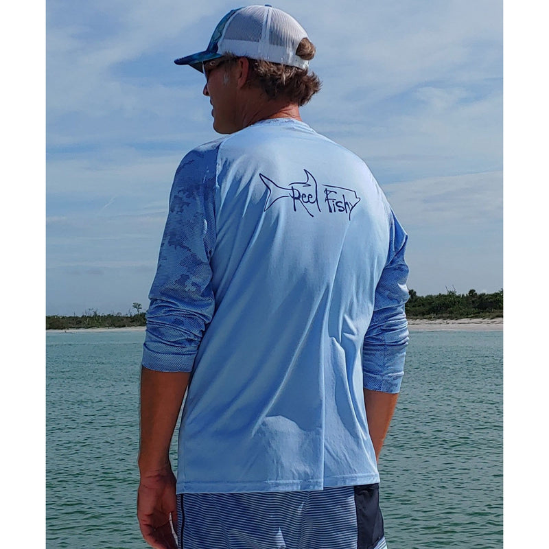 Model wearing Reel Fishy Tarpon Digital Camo Dry-Fit Long Sleeve Shirt in Blue Mist with 50+ UPF Sun Protection