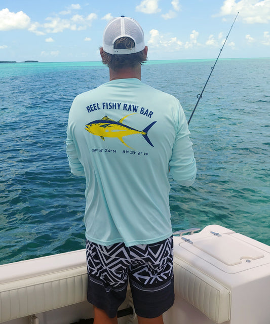 Fisherman wearing Reel Fishy Raw Bar Tuna Performance Dry-Fit Long Sleeve - Seagrass