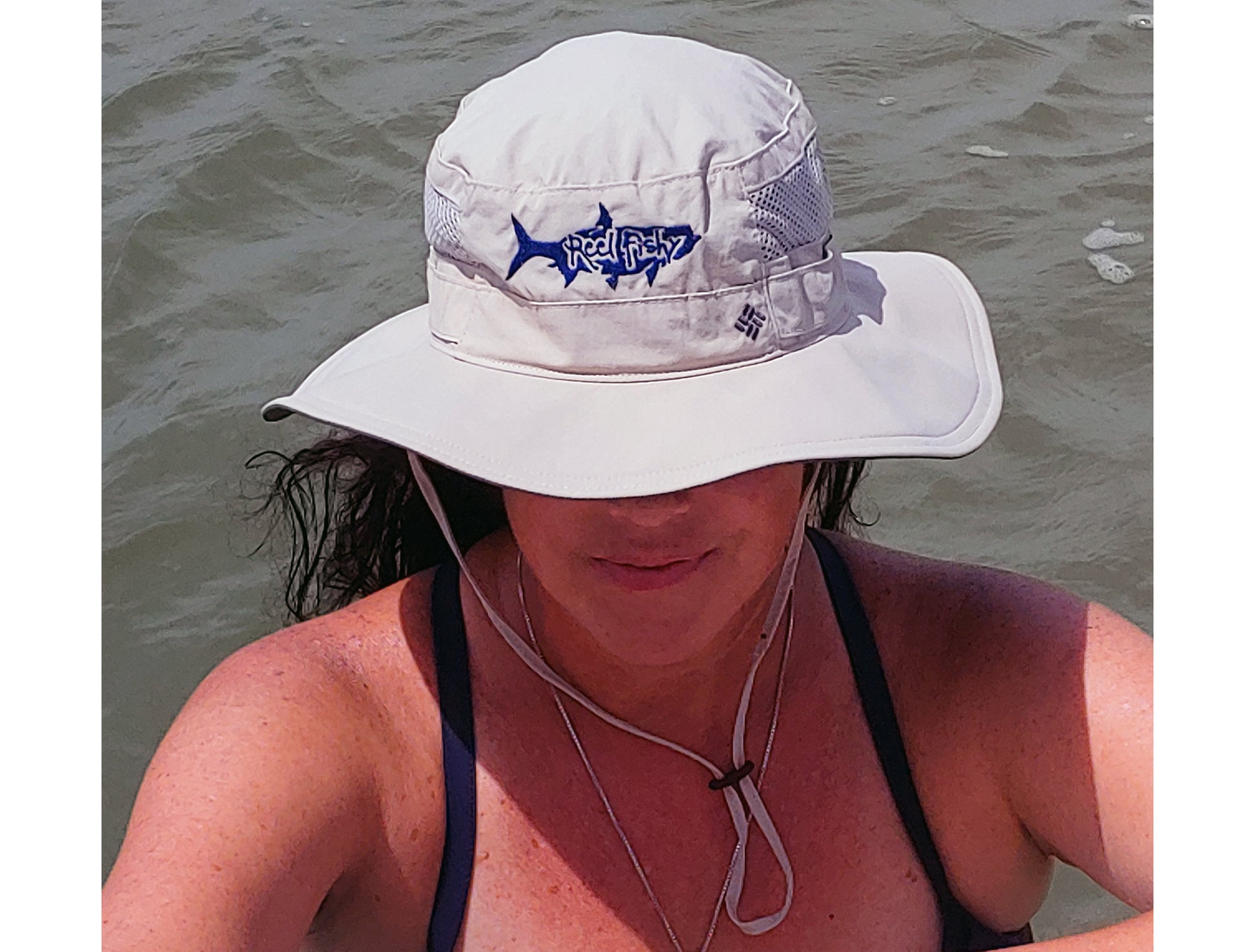 Model wearing tan boonie fishing hat with tarpon logo, 30+ UPF sun protection.