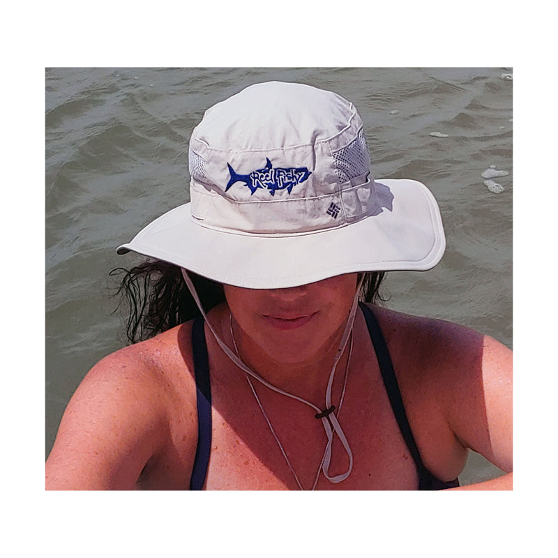Model wearing tan boonie fishing hat with tarpon logo, 30+ UPF sun protection.