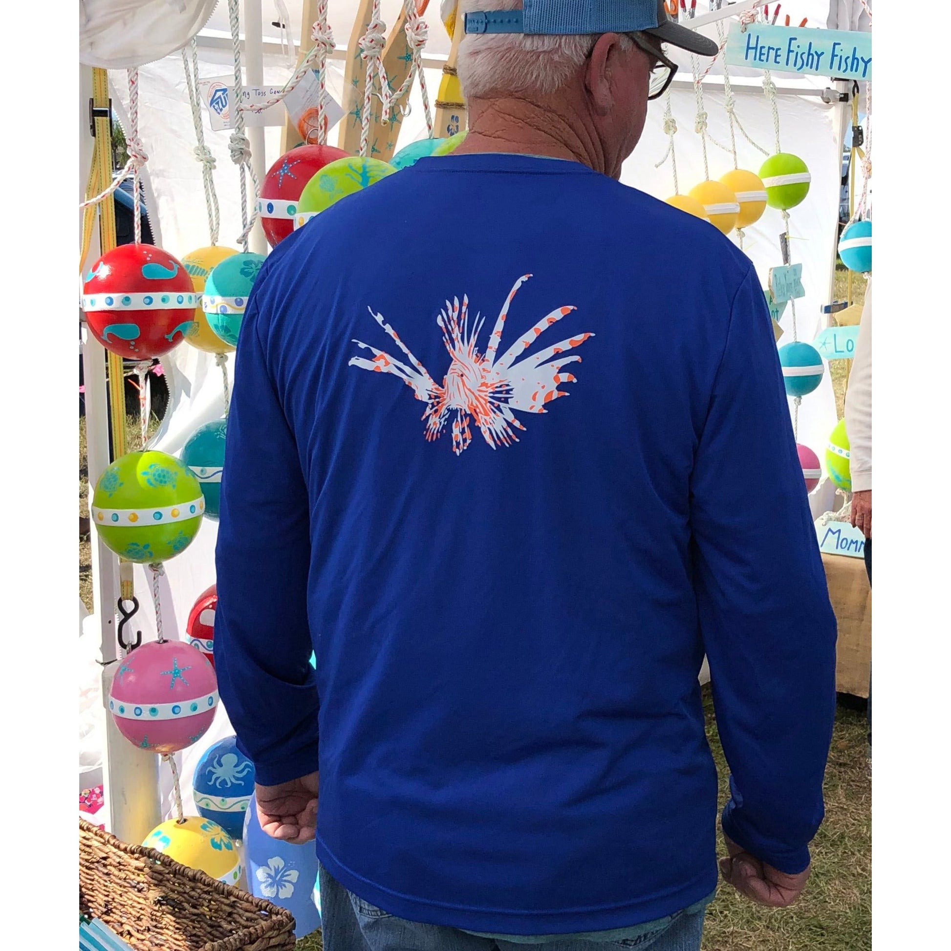 Model wearing lionfish royal blue long sleeve dry-fit performance shirt